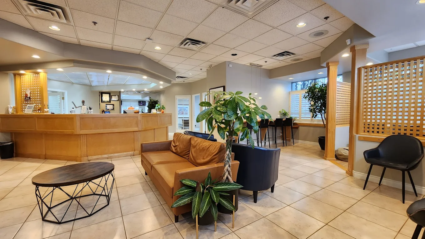 Reception area with wooden desk and comfortable seating